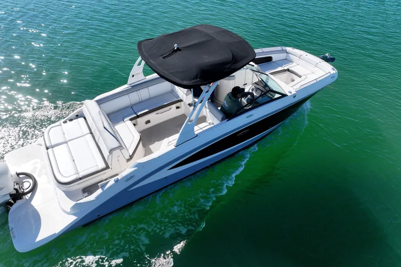 Slide: The Image of 2017 Sea Ray SDX 270 Outboard cruising on clear green water. - 4