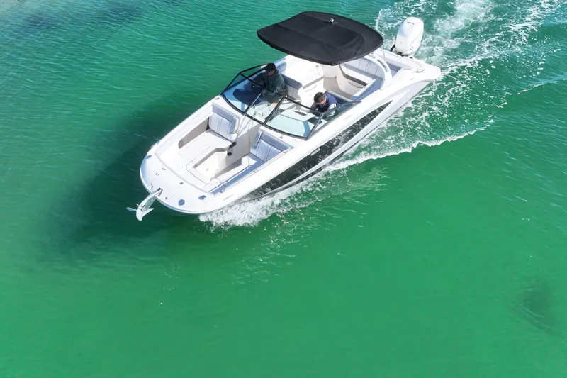 Slide: The Image of 2017 Sea Ray SDX 270 Outboard cruising on clear turquoise water. - 6