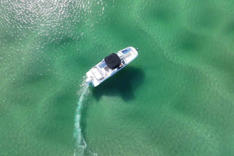 Slide: The Image of Aerial view of 2017 Sea Ray SDX 270 Outboard cruising in clear turquoise water. - 8