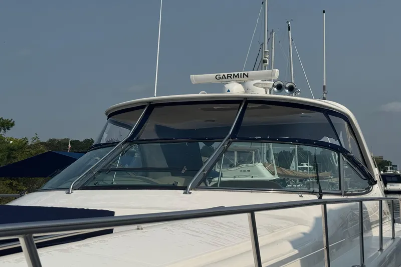 Slide: The Image of 2001 Sea Ray 540 Sundancer yacht with Garmin equipment, docked at a marina. - 11