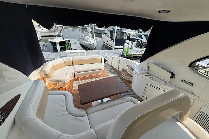 Slide: The Image of Luxurious 2001 Sea Ray 540 Sundancer yacht interior with elegant seating and wooden table. - 13