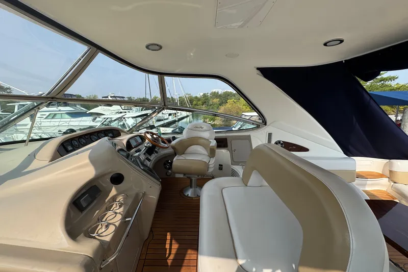 Slide: The Image of Interior of 2001 Sea Ray 540 Sundancer yacht with luxurious seating and control panel. - 14