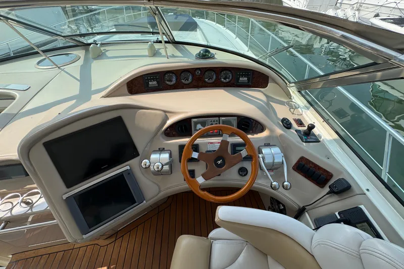 Slide: The Image of Cockpit of 2001 Sea Ray 540 Sundancer with steering wheel and control panels. - 15