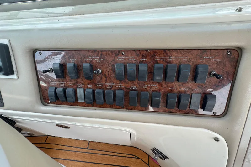 Slide: The Image of Control panel of a 2001 Sea Ray 540 Sundancer boat with switches and labels. - 17