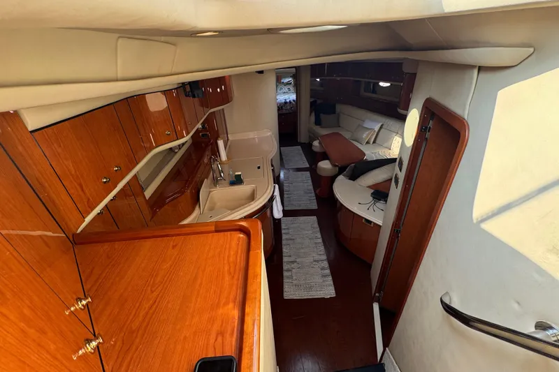 Slide: The Image of Luxurious interior of 2001 Sea Ray 540 Sundancer yacht with wood finishes and cozy seating. - 18