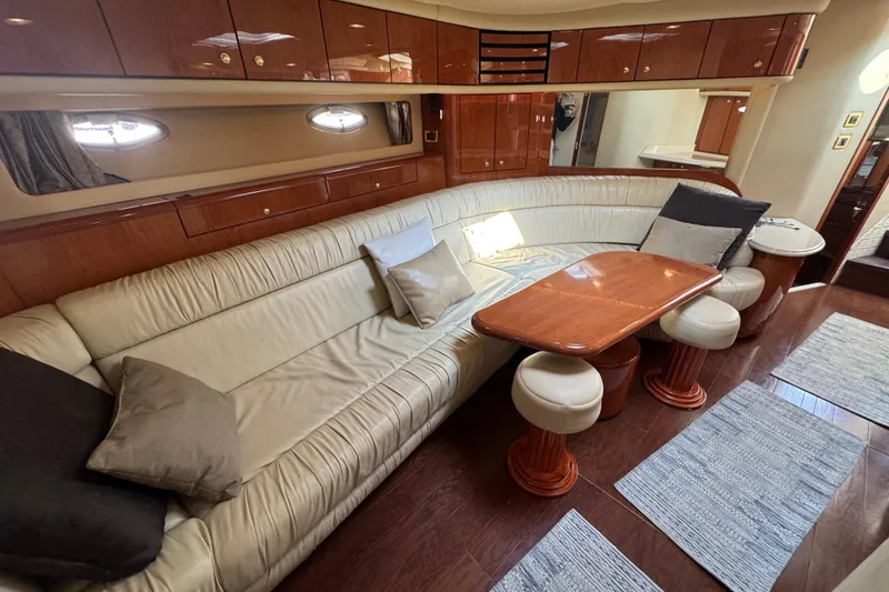 Slide: The Image of Luxurious interior of 2001 Sea Ray 540 Sundancer yacht with leather seating and wooden table. - 23