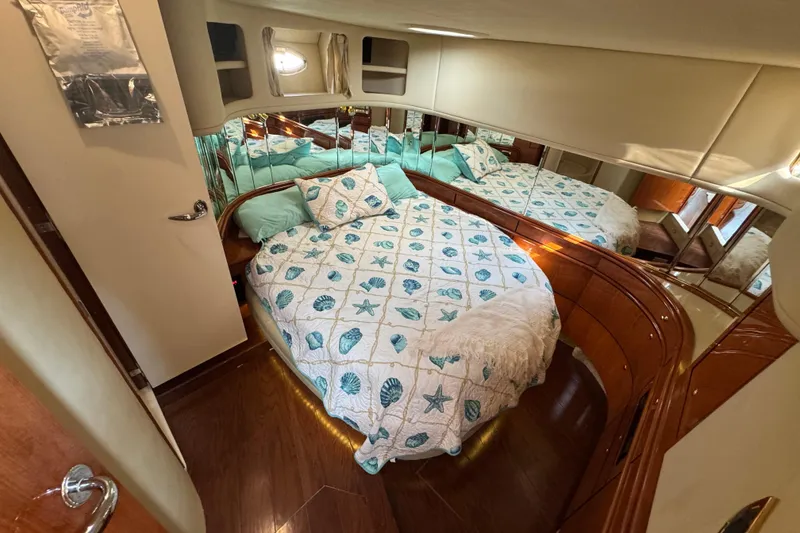 Slide: The Image of Luxurious bedroom in 2001 Sea Ray 540 Sundancer yacht with nautical-themed bedding. - 25