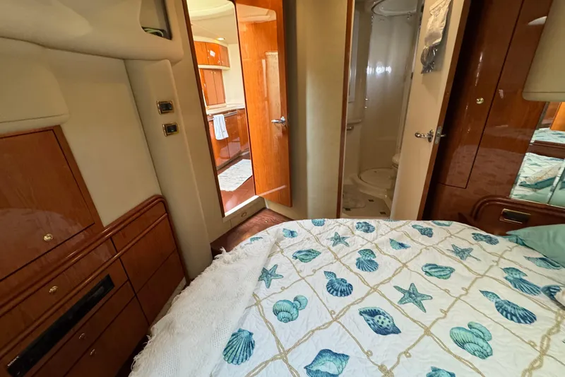 Slide: The Image of Luxurious 2001 Sea Ray 540 Sundancer cabin interior with nautical-themed bedding. - 26