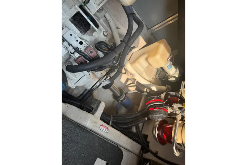 Slide: The Image of Engine compartment of a 2001 Sea Ray 540 Sundancer boat, showing hoses and components. - 34