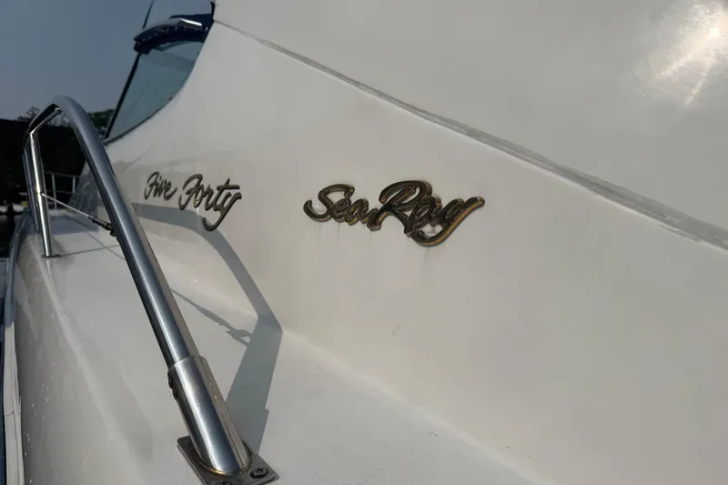 Slide: The Image of 2001 Sea Ray 540 Sundancer yacht with chrome railing and logo detail. - 6