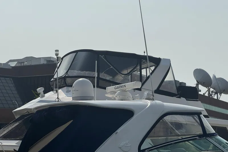 Slide: The Image of 2001 Sea Ray 540 Sundancer yacht with Garmin equipment, docked near modern buildings. - 7