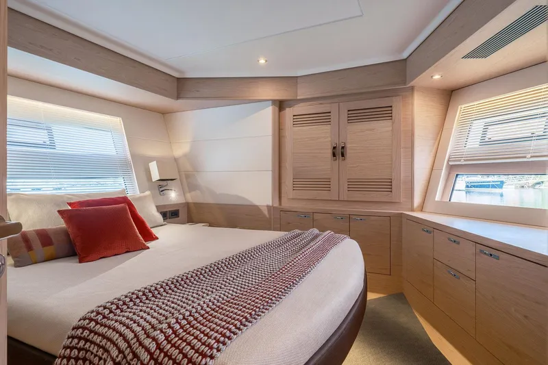 Slide: The Image of Luxurious bedroom interior of 2025 Beneteau Grand Trawler 63 yacht with modern design. - 16
