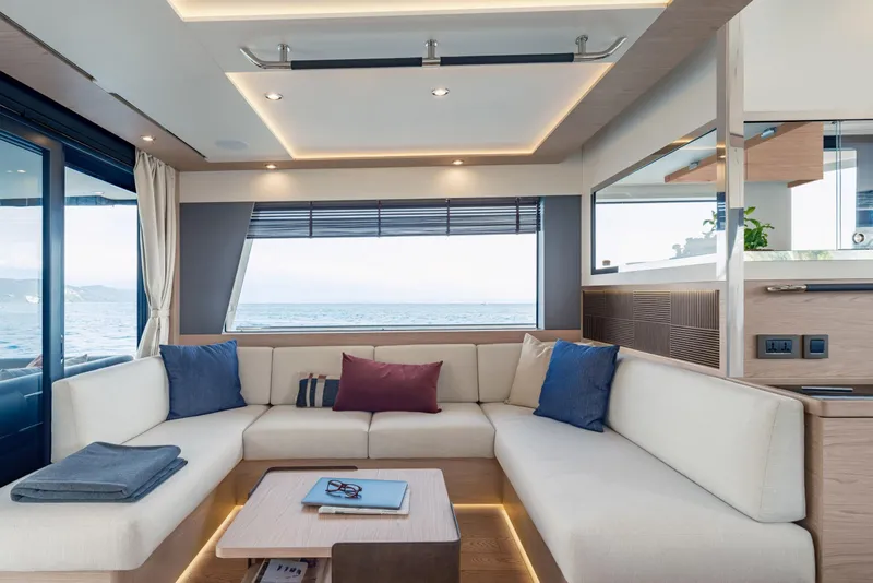 Slide: The Image of Luxurious interior of 2025 Beneteau Grand Trawler 63 with elegant seating and ocean view. - 9