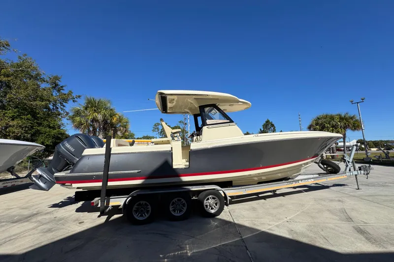 Slide: The Image of 2019 Chris-Craft Catalina 30 boat on trailer under clear blue sky. - 10