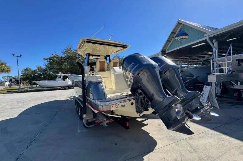 Slide: The Image of 2019 Chris-Craft Catalina 30 with twin Yamaha engines, parked outdoors. - 14