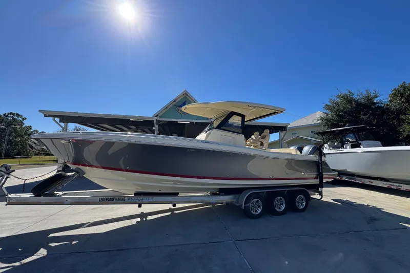 Slide: The Image of 2019 Chris-Craft Catalina 30 boat on trailer under clear blue sky. - 2