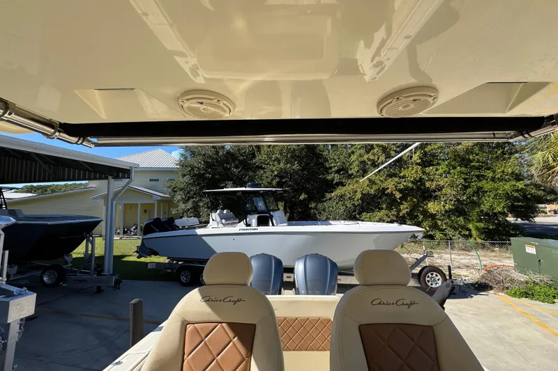 Slide: The Image of 2019 Chris-Craft Catalina 30 boat interior with luxurious seating and outdoor view. - 26