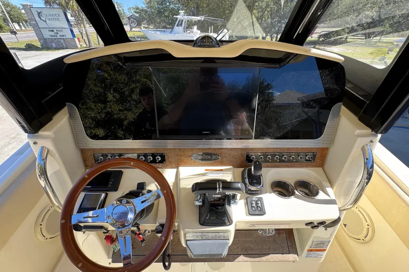 Slide: The Image of 2019 Chris-Craft Catalina 30 helm with steering wheel, controls, and display screen. - 29
