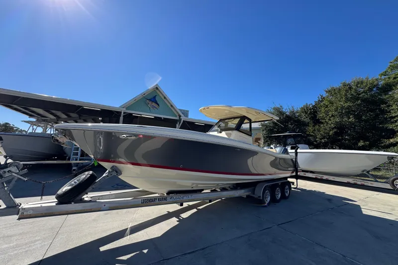 Slide: The Image of 2019 Chris-Craft Catalina 30 boat on trailer under clear blue sky. - 3