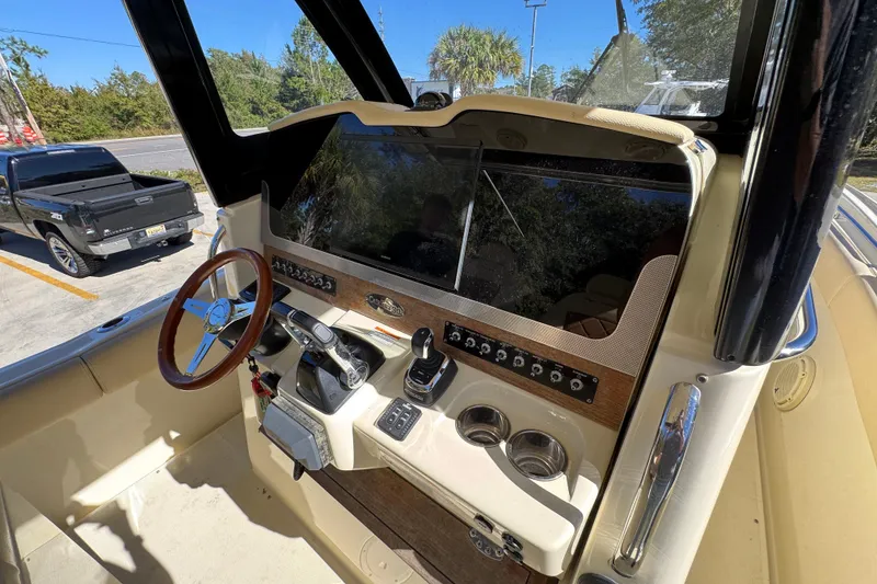 Slide: The Image of 2019 Chris-Craft Catalina 30 helm with steering wheel and control panel. - 30