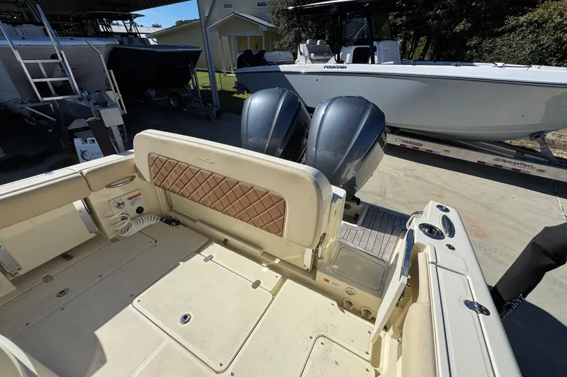 Slide: The Image of 2019 Chris-Craft Catalina 30 boat with dual outboard engines, docked outdoors. - 34