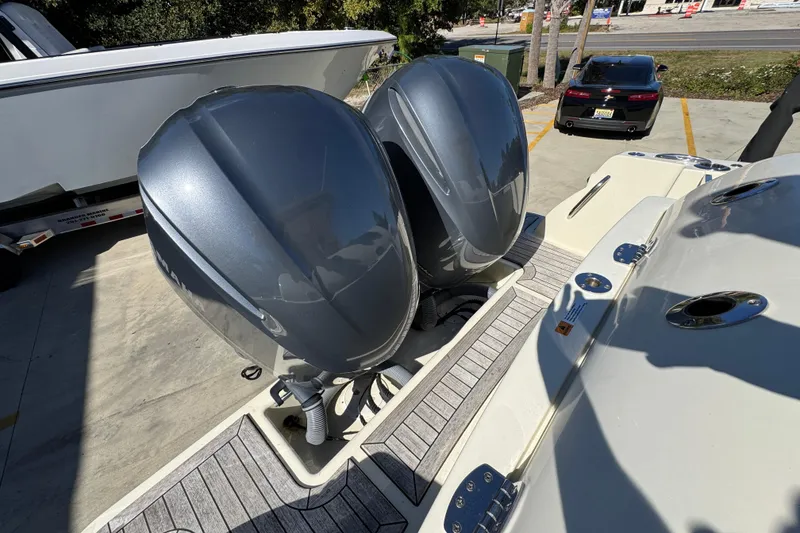 Slide: The Image of 2019 Chris-Craft Catalina 30 with dual outboard engines, docked on a sunny day. - 37