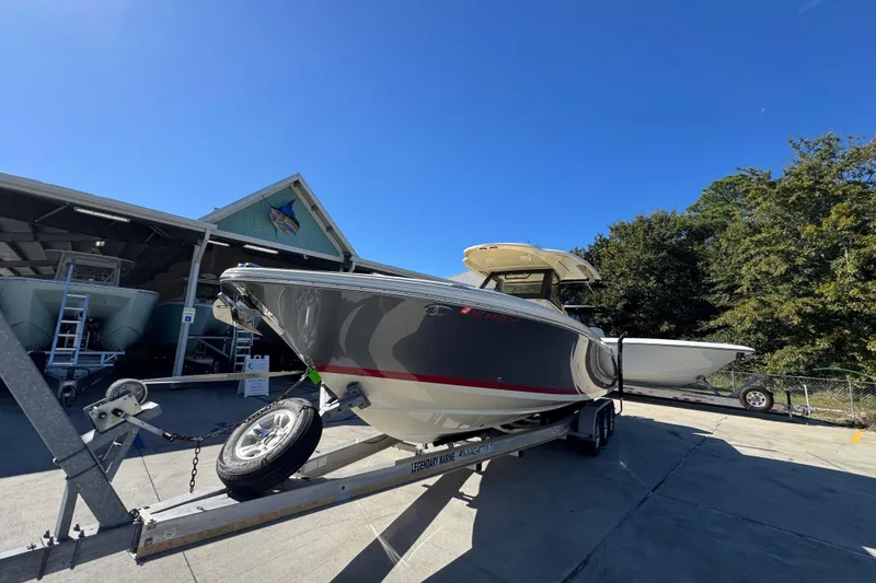Slide: The Image of 2019 Chris-Craft Catalina 30 boat on trailer under clear blue sky. - 4