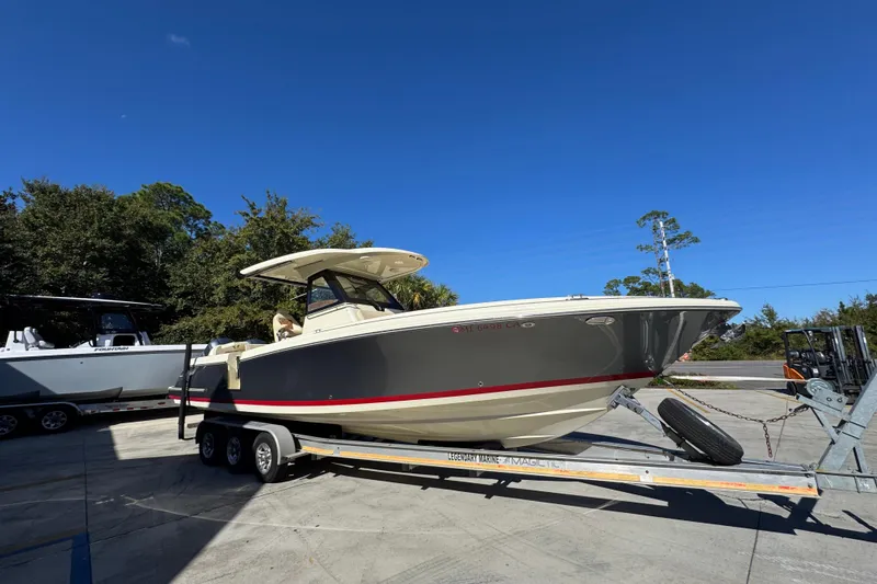 Slide: The Image of 2019 Chris-Craft Catalina 30 boat on trailer under clear blue sky. - 8