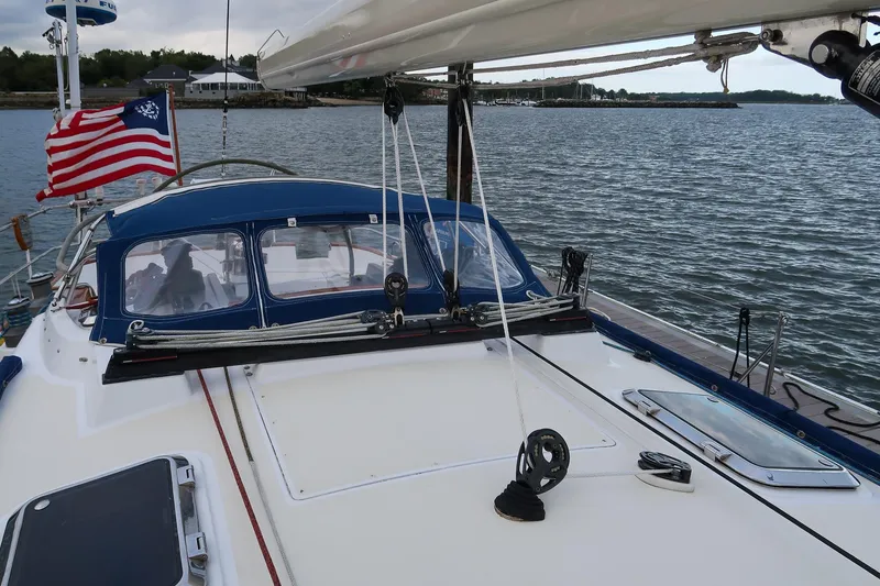 Slide: The Image of Sailboat Morris Ocean Series 45, 2007 model, with American flag on calm waters. - 18