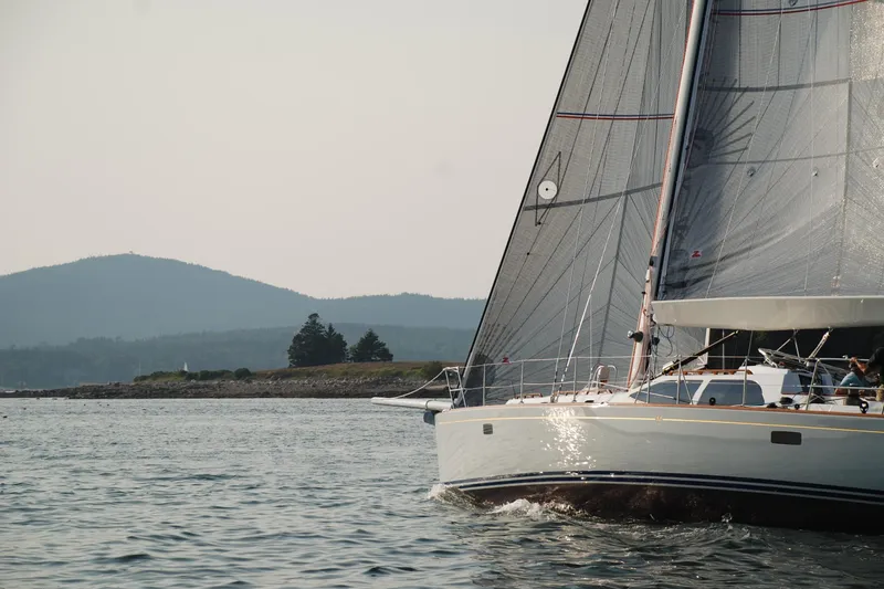 Slide: The Image of Sailing yacht Morris Ocean Series 45, 2007, gliding on serene waters near a mountainous coastline. - 2