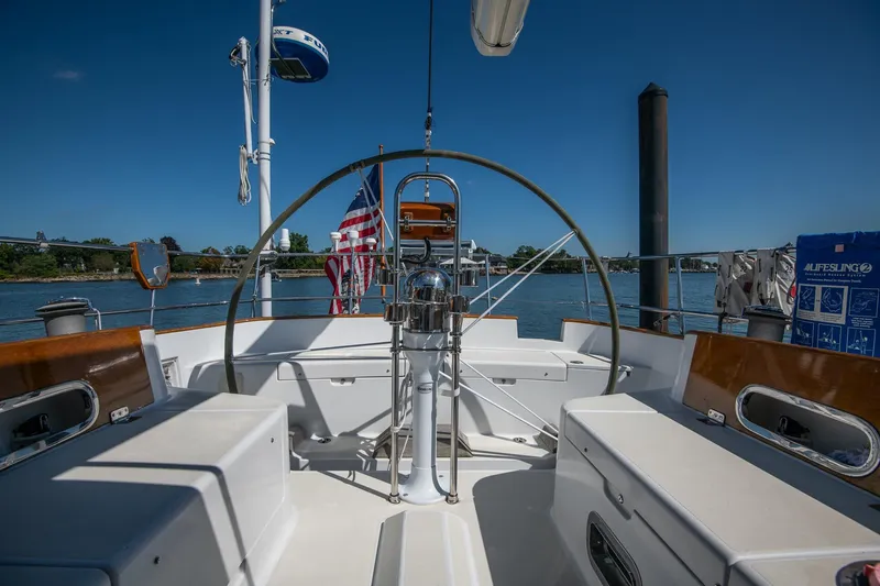 Slide: The Image of Cockpit view of 2007 Morris Ocean Series 45 sailboat with American flag, docked on a sunny day. - 26