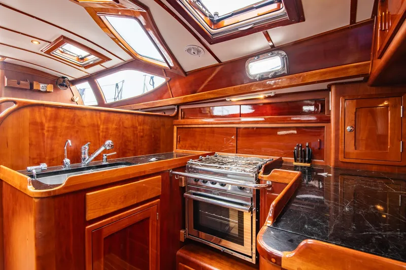 Slide: The Image of Luxurious 2007 Morris Ocean Series 45 yacht kitchen with wood finish and modern appliances. - 40