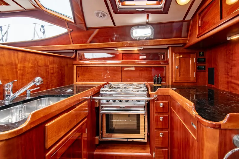 Slide: The Image of Luxurious 2007 Morris Ocean Series 45 yacht kitchen with wood cabinetry and modern appliances. - 41