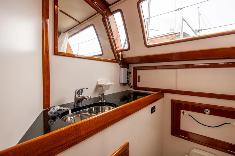 Slide: The Image of Interior of 2007 Morris Ocean Series 45 yacht, featuring a compact sink and wooden accents. - 50