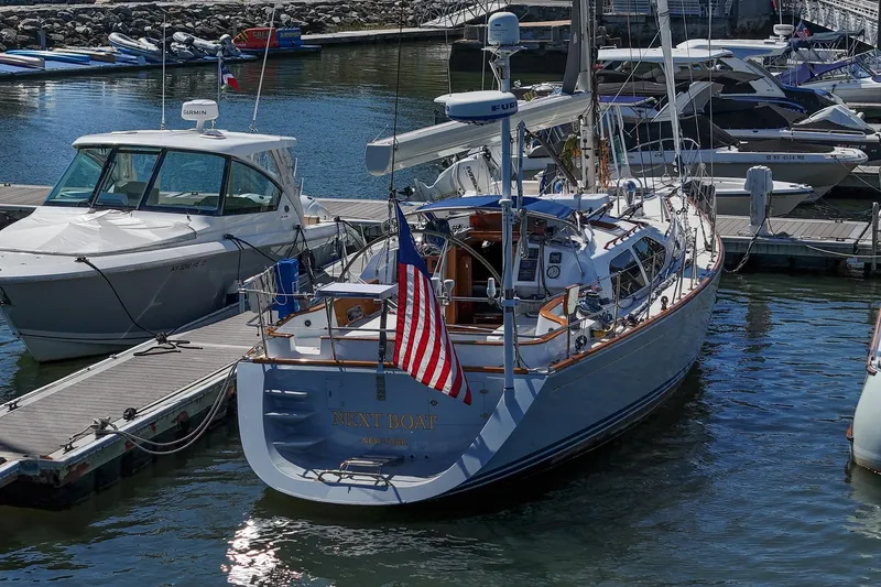 Slide: The Image of Sailboat "Next Boat," Morris Ocean Series 45, 2007, docked at marina with American flag. - 8