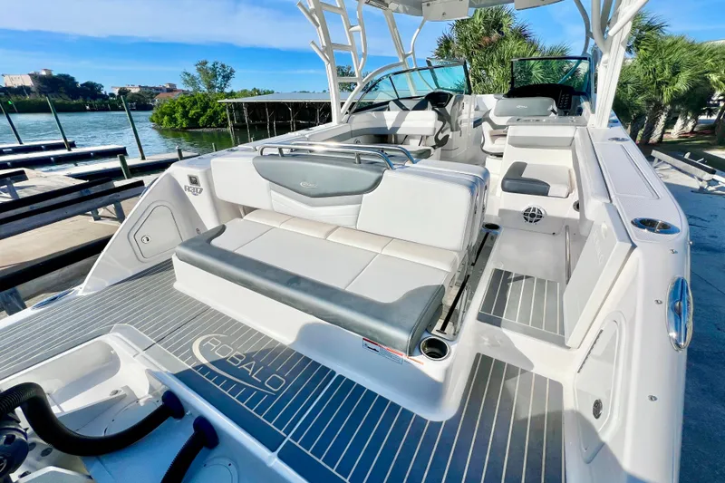 Slide: The Image of 2021 Robalo R317 Dual Console boat interior with seating and sink, docked outdoors. - 10