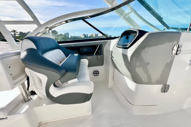 Slide: The Image of 2021 Robalo R317 Dual Console boat interior with seating, helm, and sink. - 16
