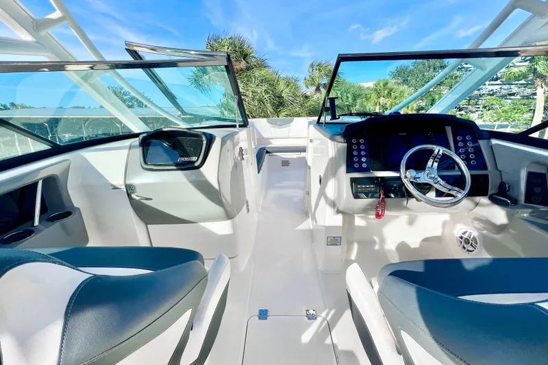 Slide: The Image of 2021 Robalo R317 Dual Console boat interior with modern helm and seating. - 17