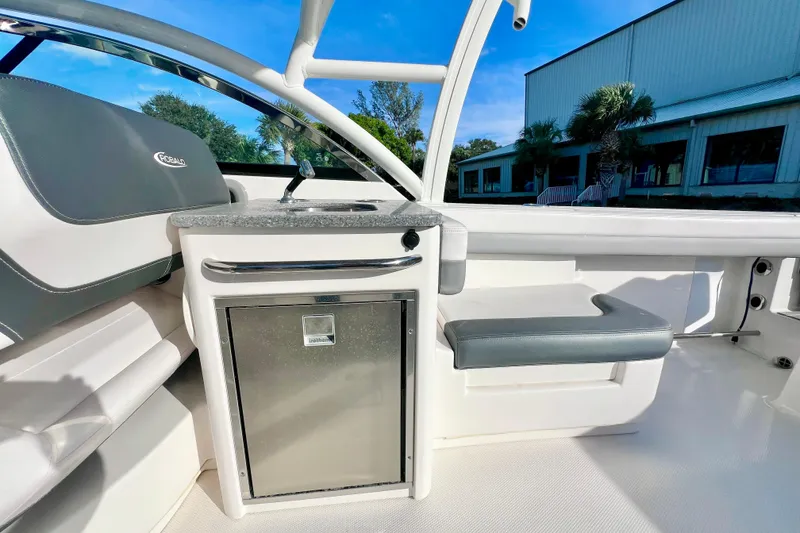 Slide: The Image of 2021 Robalo R317 Dual Console boat dashboard with steering wheel and control panel. - 19