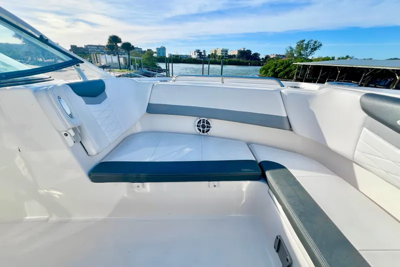 Slide: The Image of 2021 Robalo R317 Dual Console boat interior with white seating and speakers. - 21