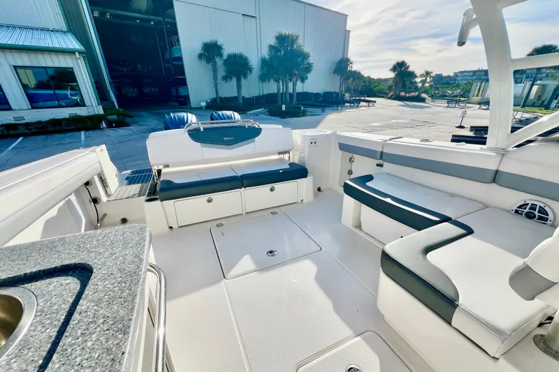 Slide: The Image of 2021 Robalo R317 Dual Console with twin outboard engines at a marina. - 9