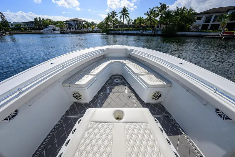 Slide: The Image of 2021 Yellowfin 42 boat interior with luxurious seating on a scenic waterfront. - 18