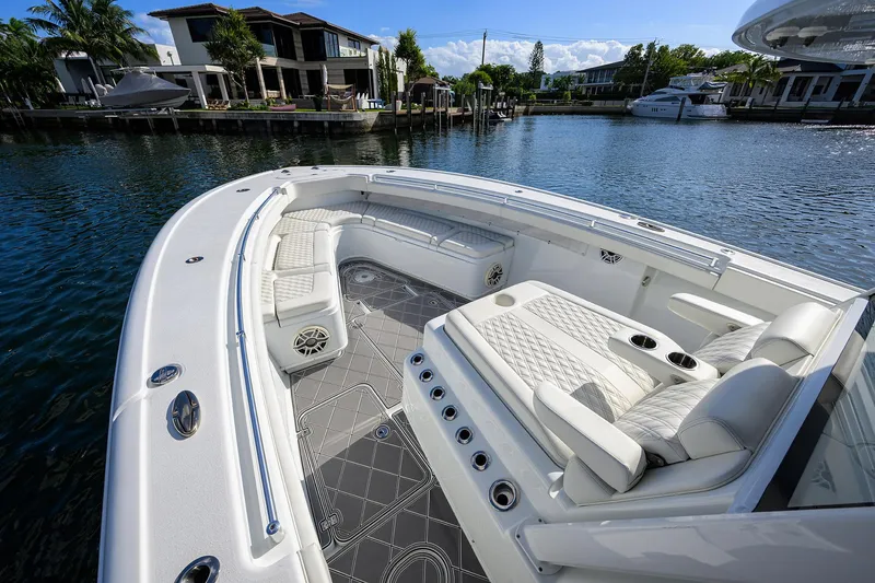 Slide: The Image of 2021 Yellowfin 42 boat with luxurious seating, docked near waterfront homes. - 26