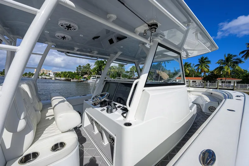 Slide: The Image of 2021 Yellowfin 42 boat interior with helm, white seating, and waterfront view. - 28