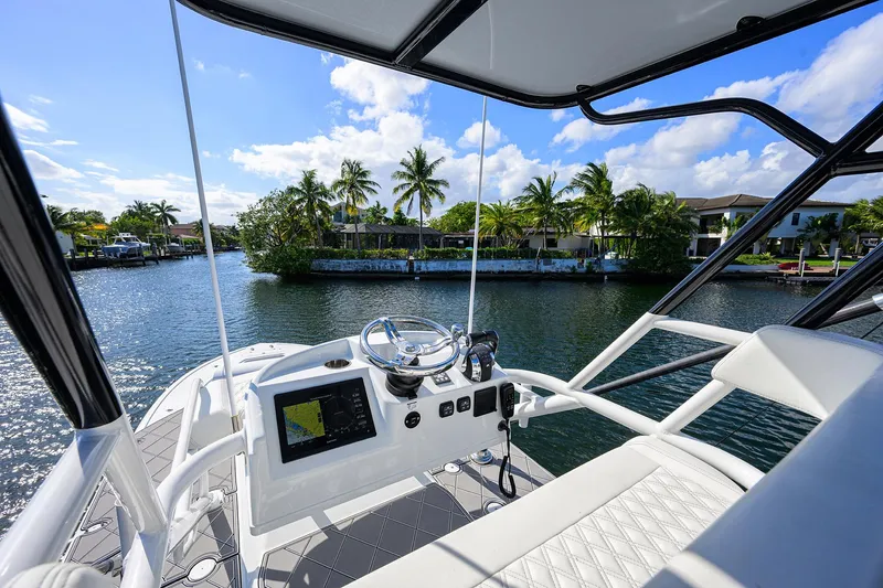 Slide: The Image of 2021 Yellowfin 42 boat interior with steering console, on a sunny day by the water. - 37