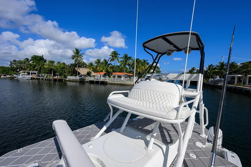 Slide: The Image of 2021 Yellowfin 42 boat on calm water with clear blue sky and palm trees. - 38