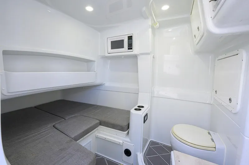Slide: The Image of 2021 Yellowfin 42 interior cabin with bed, microwave, and toilet. - 44
