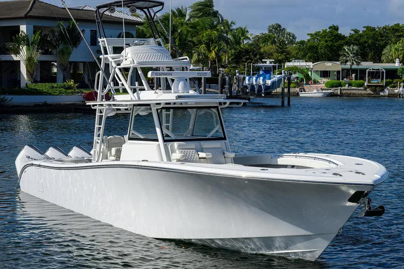 Slide: The Image of 2021 Yellowfin 42 boat on calm water near waterfront homes. - 5