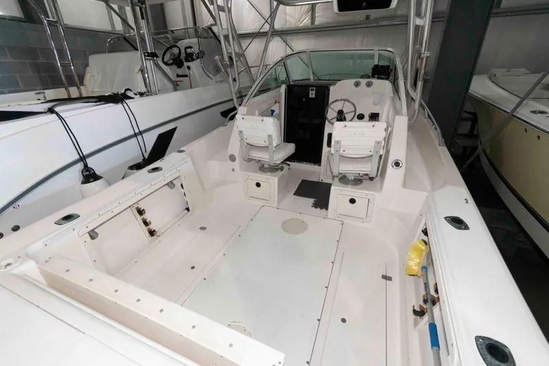 Slide: The Image of 1999 Mako 253 Walk Around boat interior with dual seats and steering console. - 4
