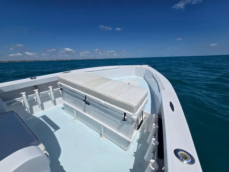 Slide: The Image of 2012 Contender Custom 33 Center Console boat on open sea under clear blue sky. - 11